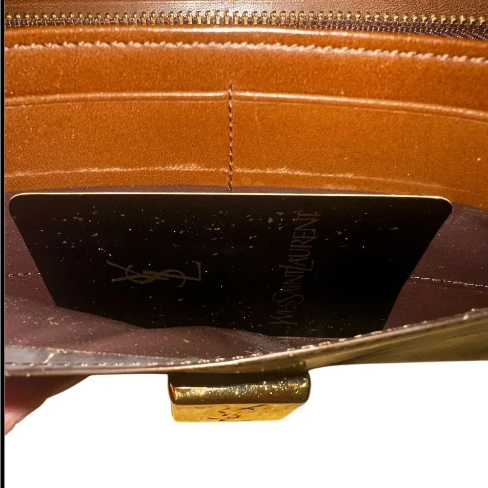 Yves Saint Laurent Tan Leather Wallet with Gold Clasp with marks and scratches.